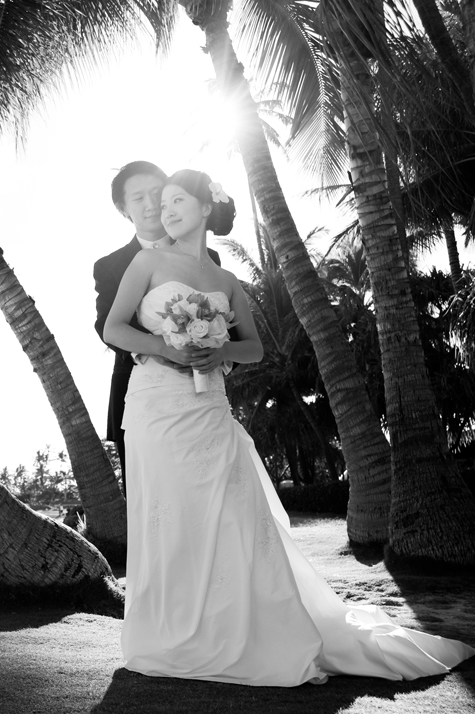 Bride and Groom Embrace on Beach