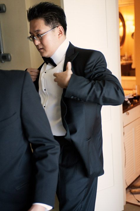 Groom getting into Tux