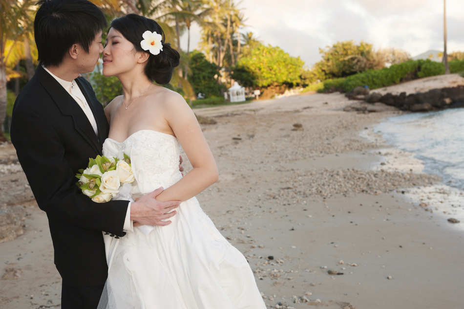 Bride and Groom Kiss near Kahala Resort