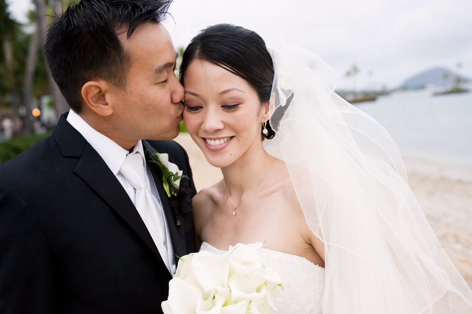 Groom kisses Bride on Waialae Beach