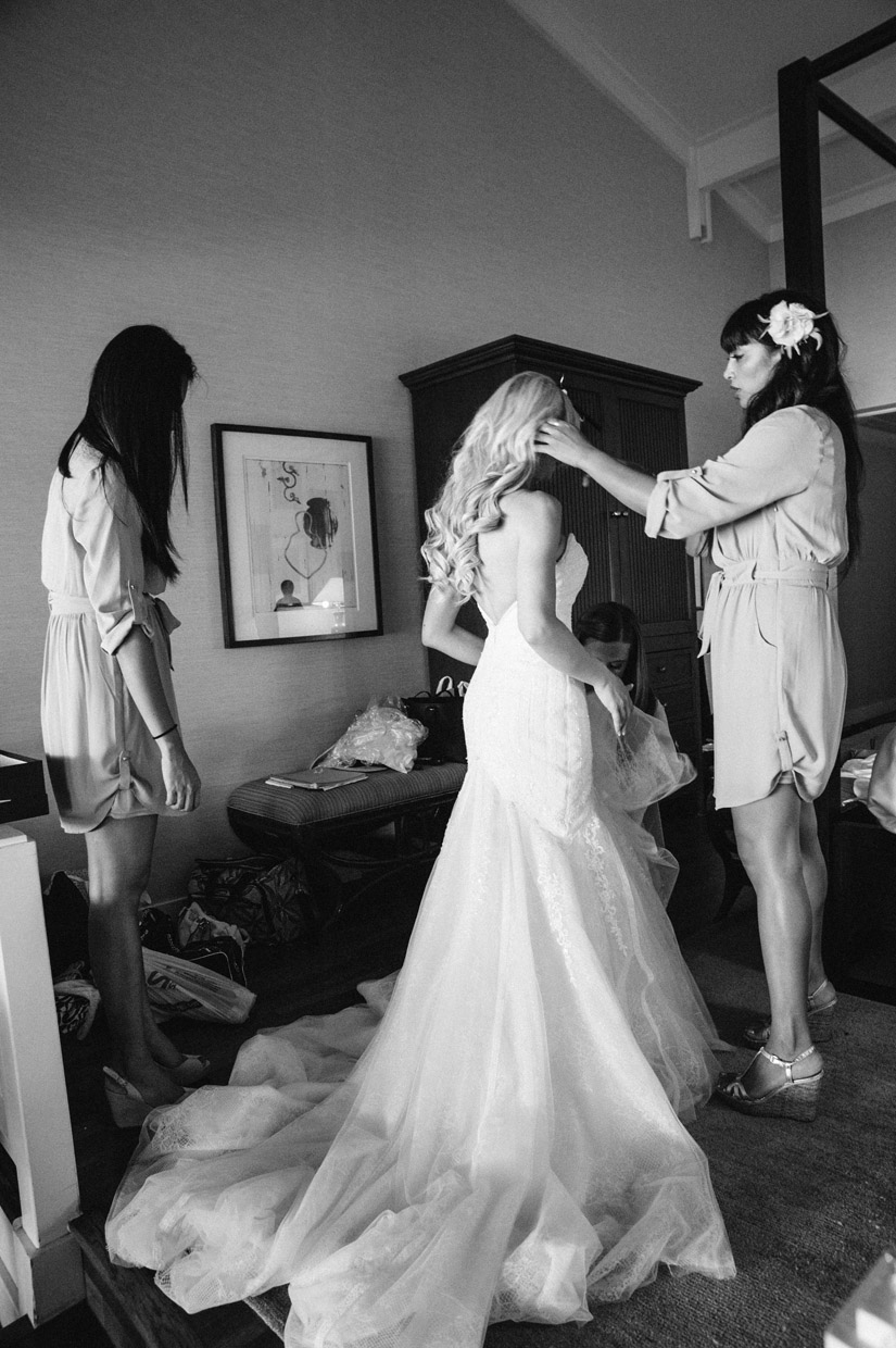 Bridesmaids helping Bride