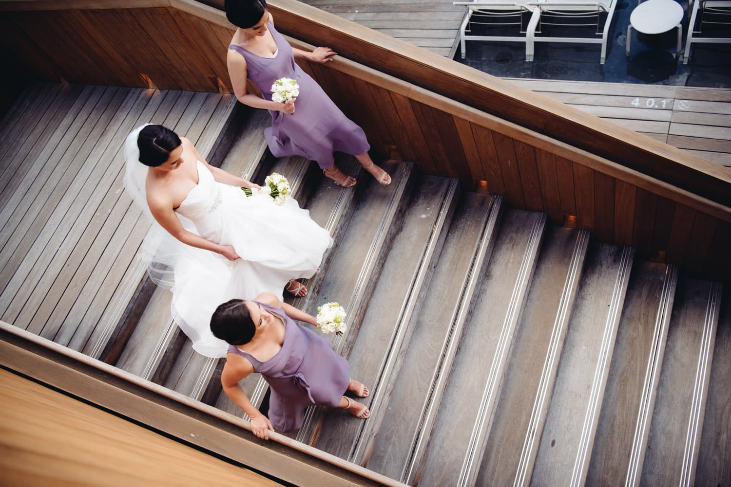 Bride and Bridesmaids Walking down staircase at The Modern Honolulu