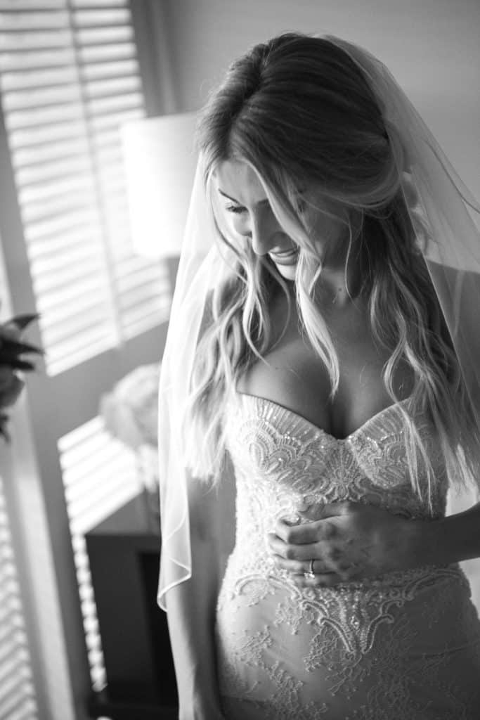 Black and White image of bride getting ready in Four Seasons Suite
