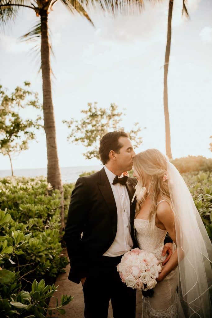 Bride & Groom kissing at Four Seasons Resort Oahu at Koolina