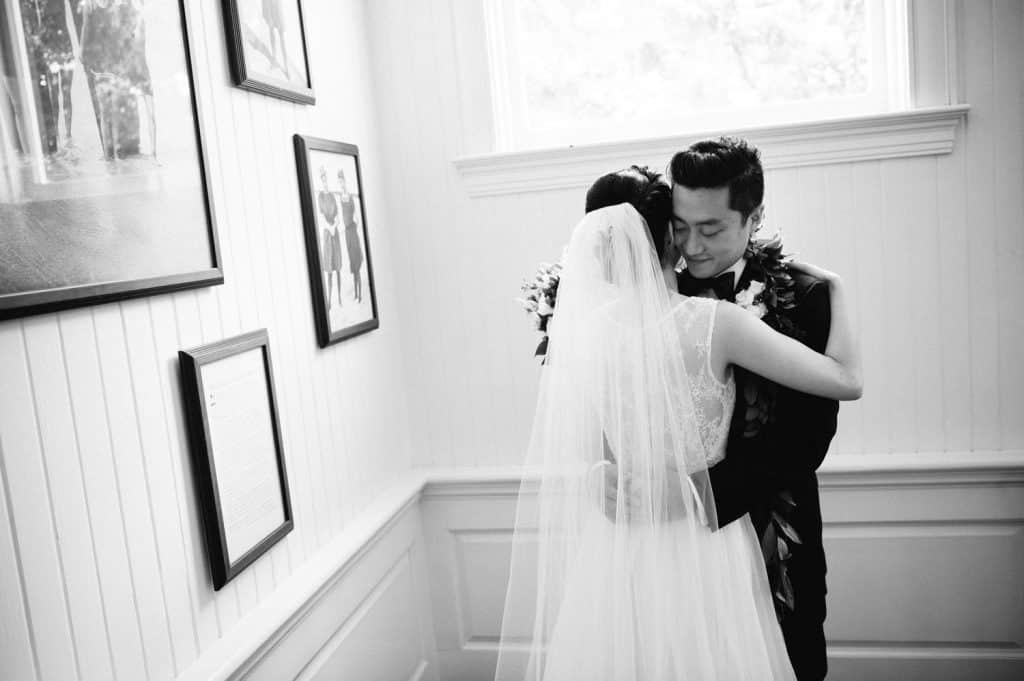 Black and White image of Bride and Groom Hugging on Moana Grand Staircase