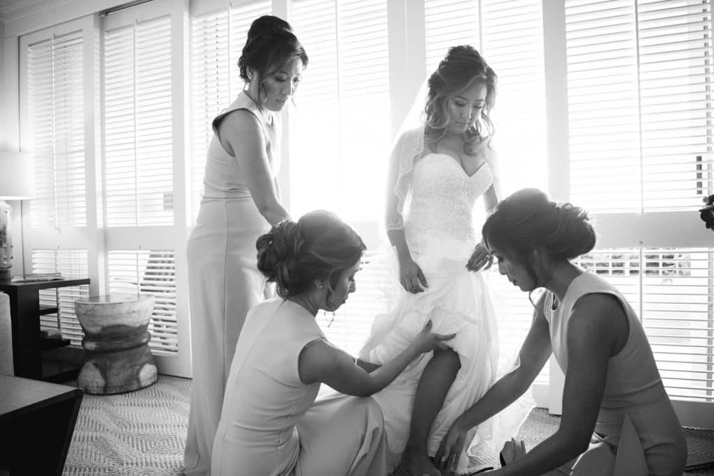 Black and White image of bride and bridesmaids getting ready