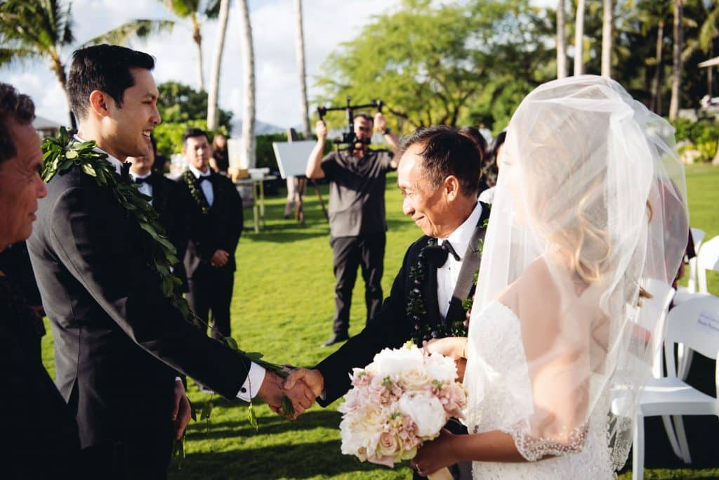 Father of Bride shaking hands with groom at four seasons resort Oahu at Koolina