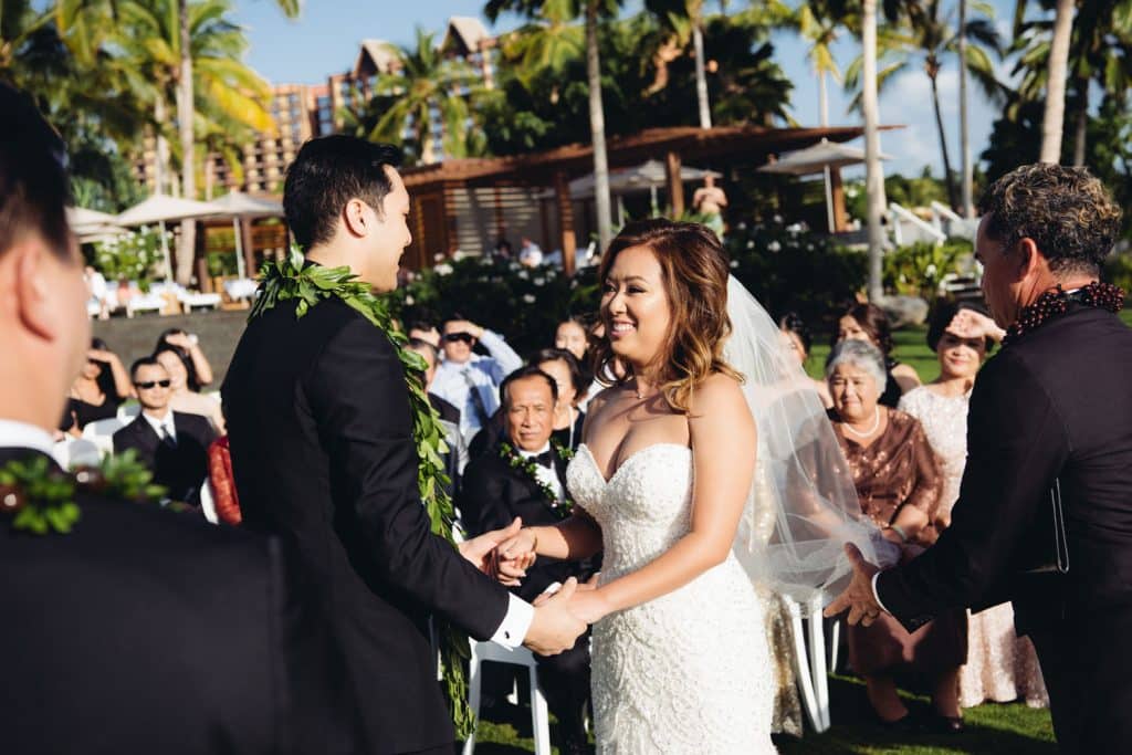 Bride and Groom exchanging wedding vows at Four Seasons Oahu