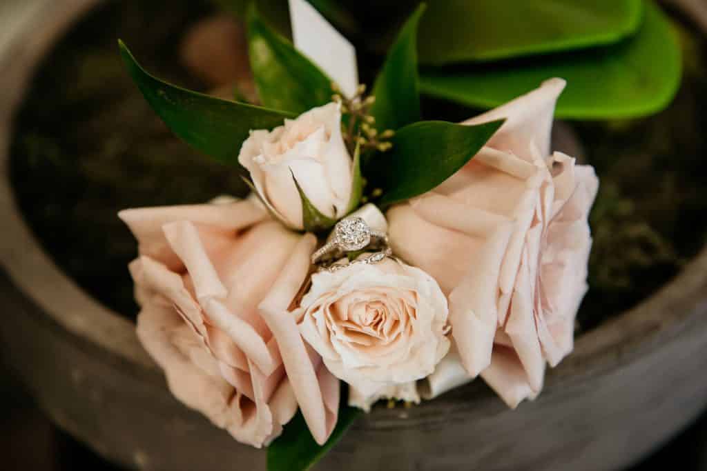 Cushion Cut Engagement Ring Styled in Pink Roses