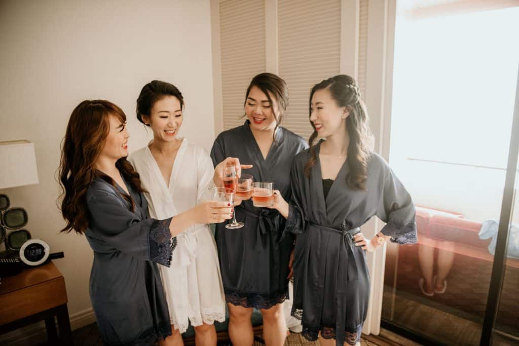 Bride and Bridesmaids toasting in blue robes
