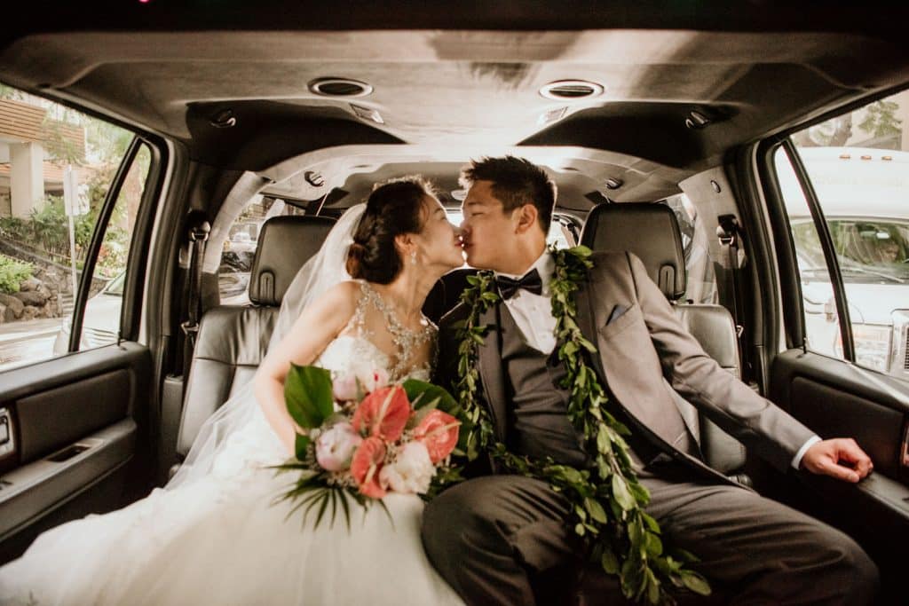Bride in Groom kiss in limo waikiki