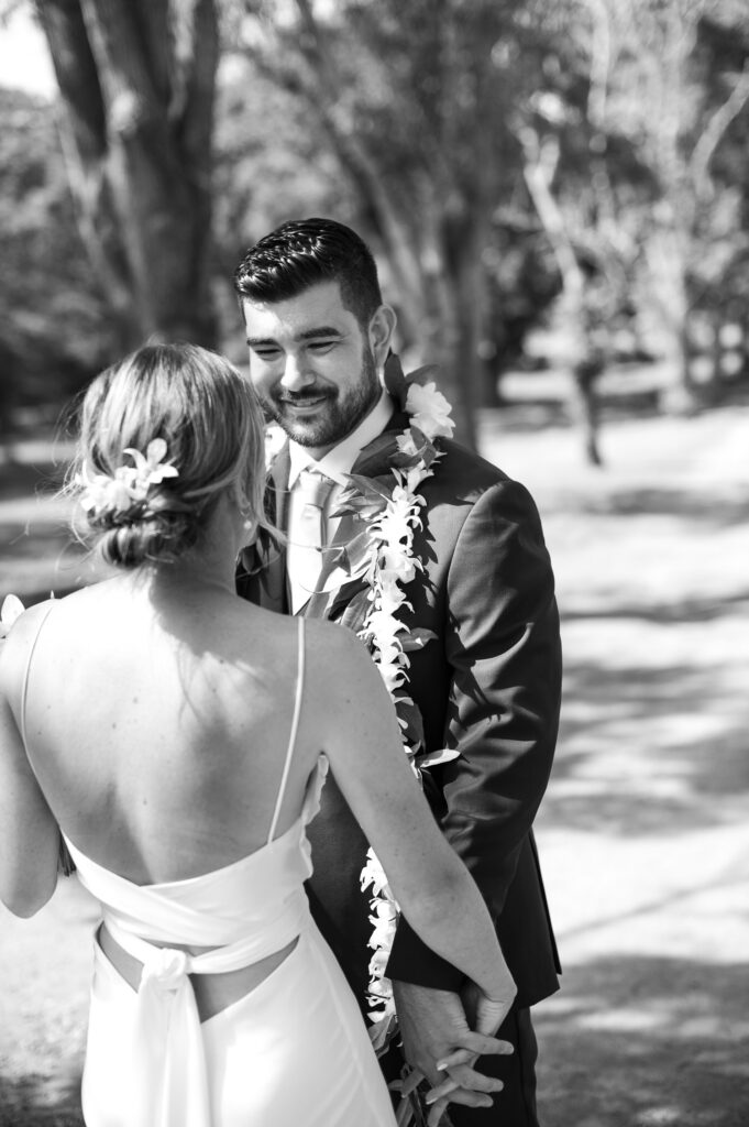 Black and white image of bride and groom's first look.