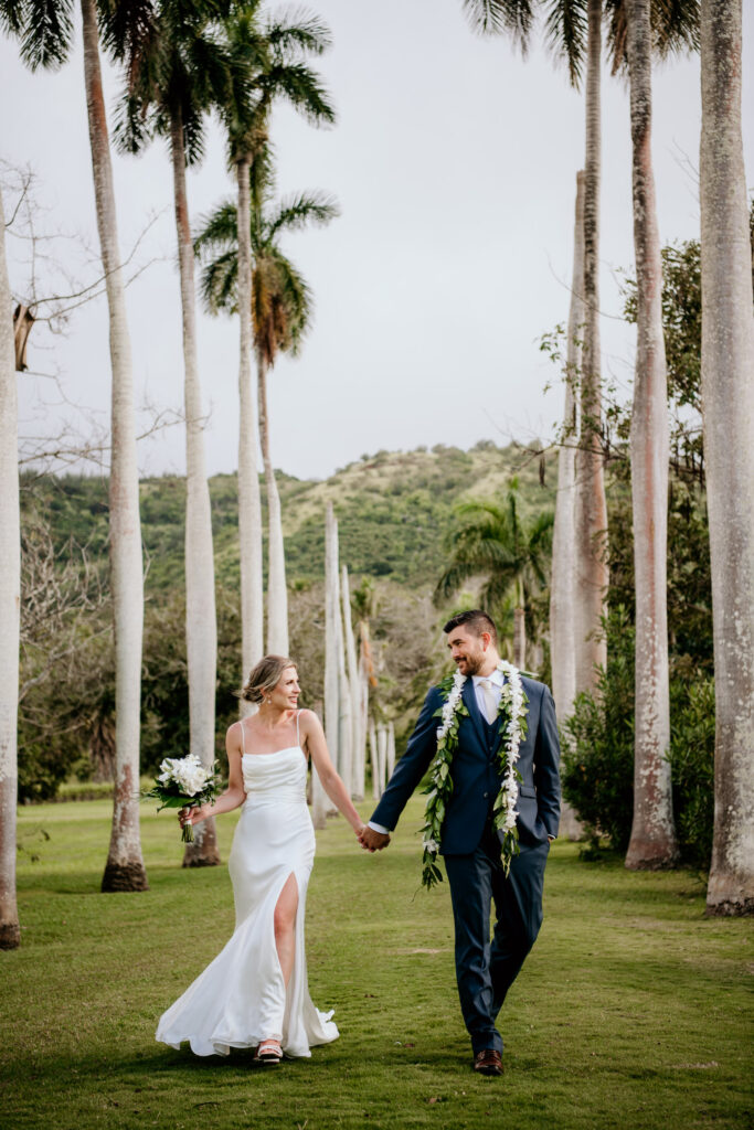 Bride and Groom walking elegantly among the palm trees at Dillingham Ranch.