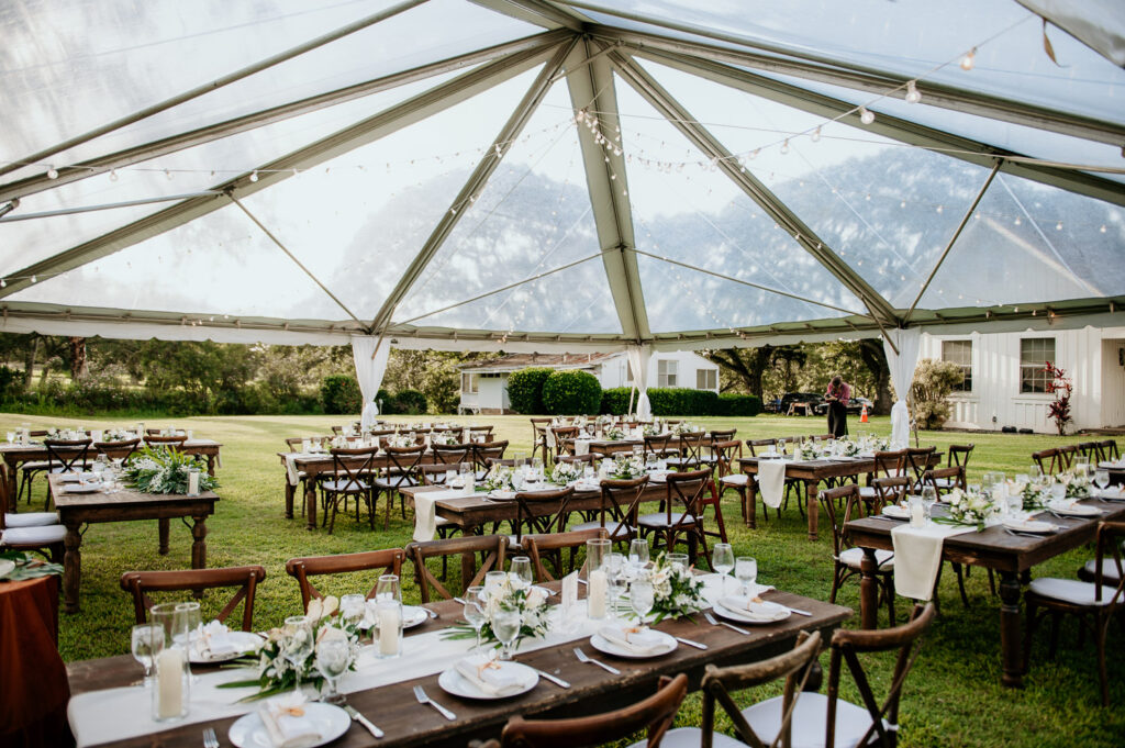Clear tent by Accel rentals with wedding reception details.