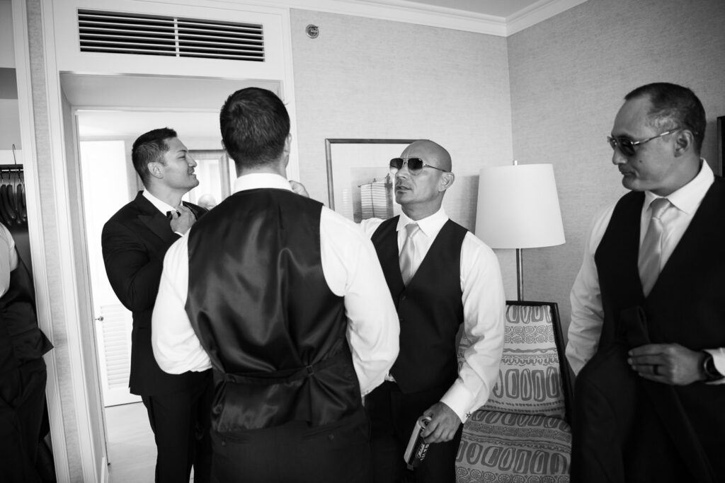 Black and White image of groomsmen getting ready at FS Oahu