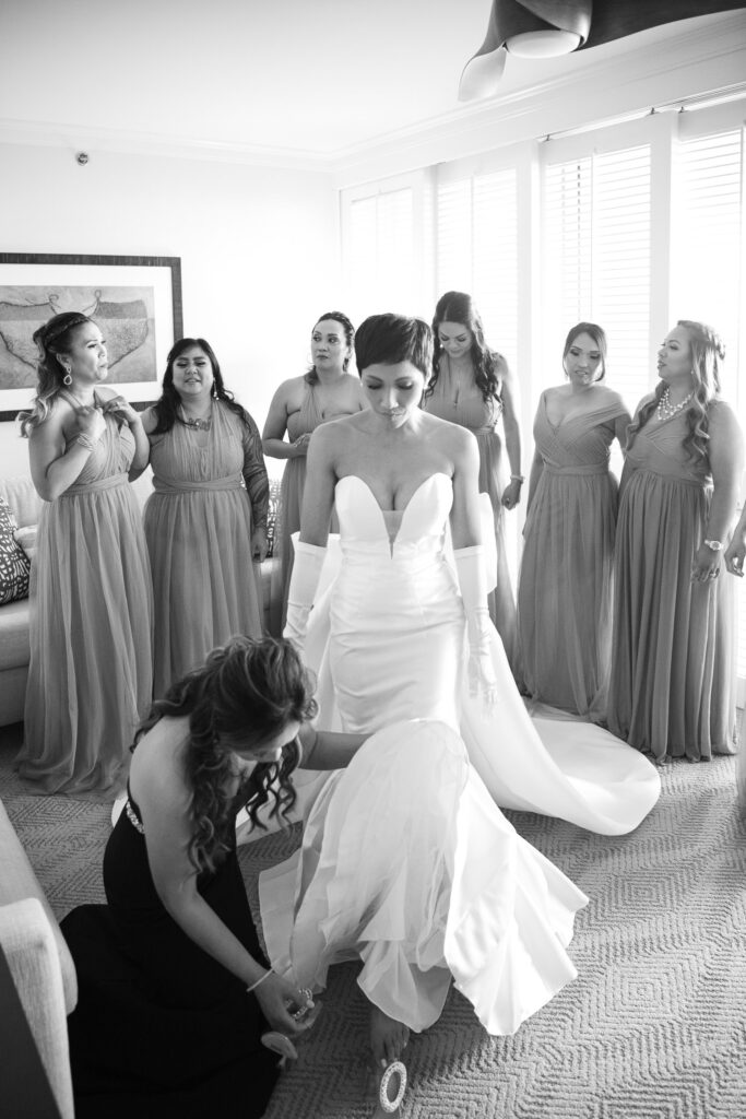 Black and White image of bride with bridesmaids at four seasons Oahu at Koolina.