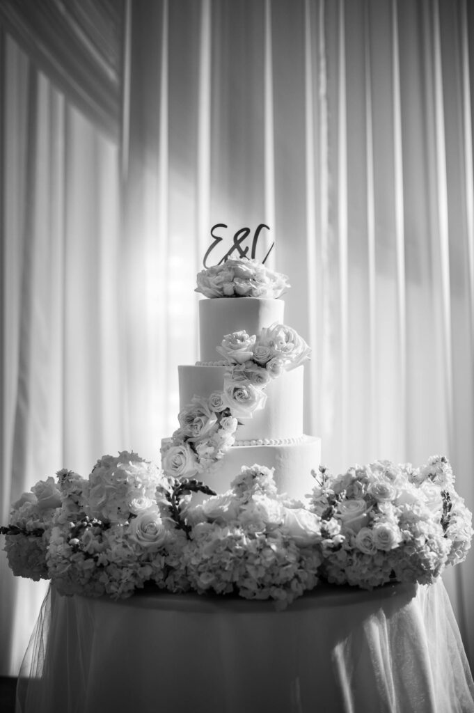 Black and White image of wedding cake displayed in the Ocean Ballroom of the Four Seasons Resort Oahu at Koolina.