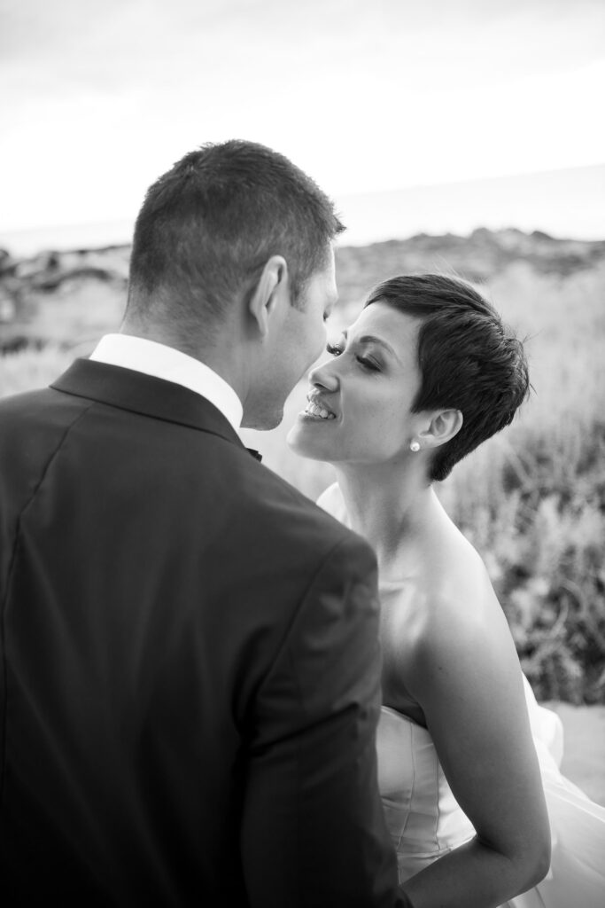 Black and White image of Bride kissing Room at FS Oahu.