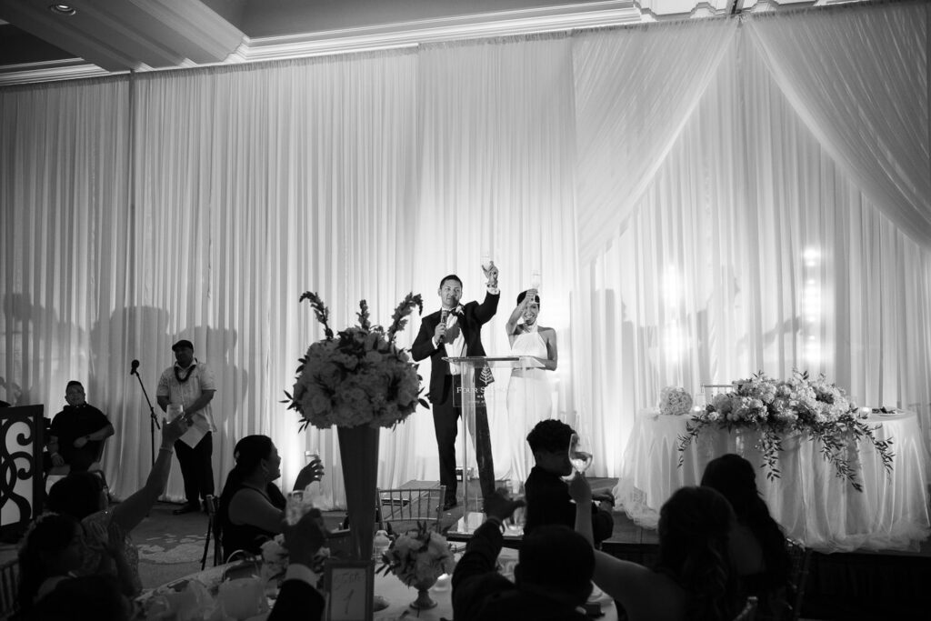 Black and White image of wedding speeches at Ocean Ballroom at the Four Seasons Resort Oahu at Koolina.