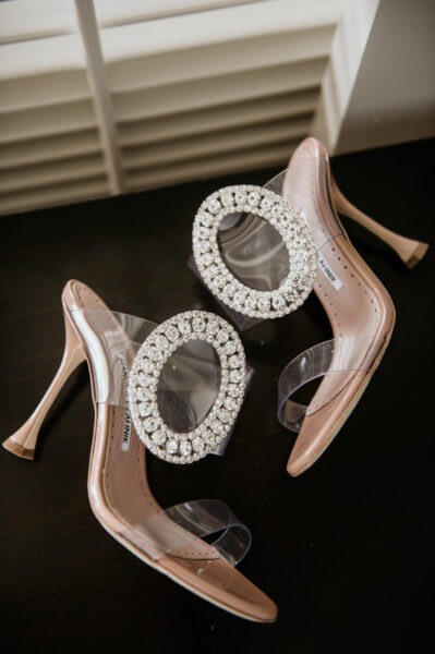 Manolo Blahnik wedding shoes displayed on table of Four Seasons Hotel Suite.