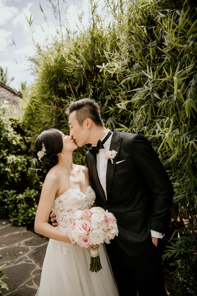 Bride and Groom kiss bamboo