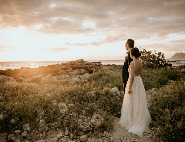 Bride and Groom at Secret Beach in front of Four Seasons Resort Oahu at Koolina
