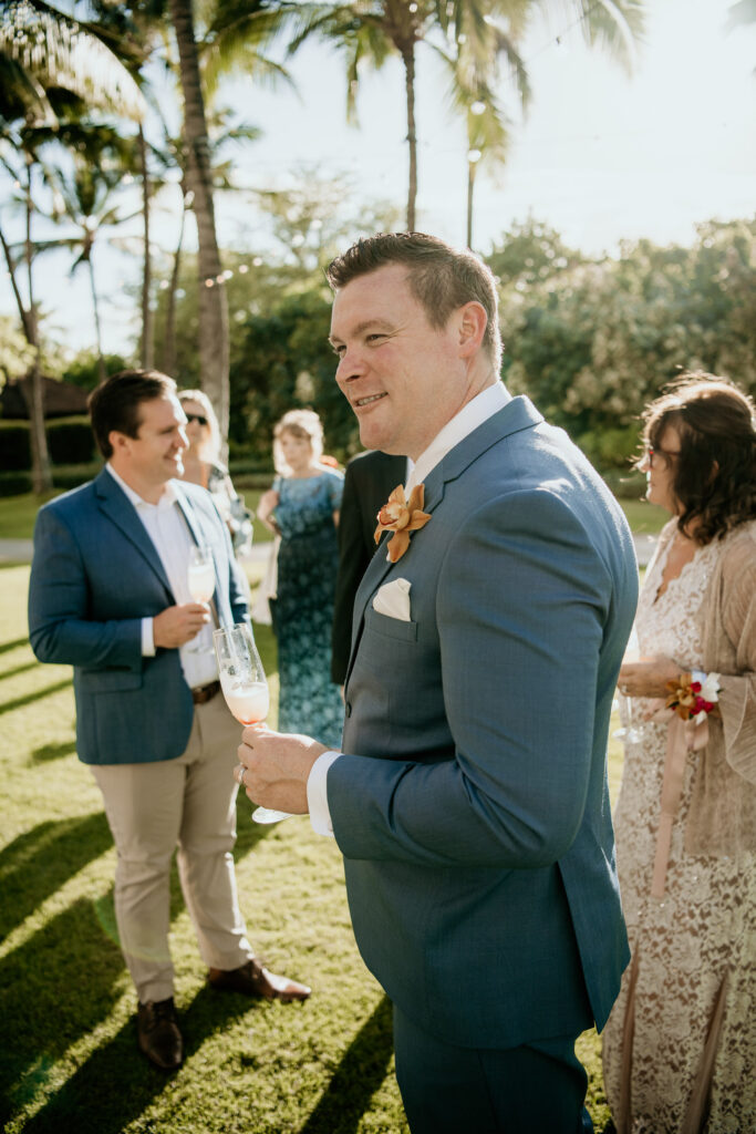 Groom at Cocktail Hour with drink in hand.