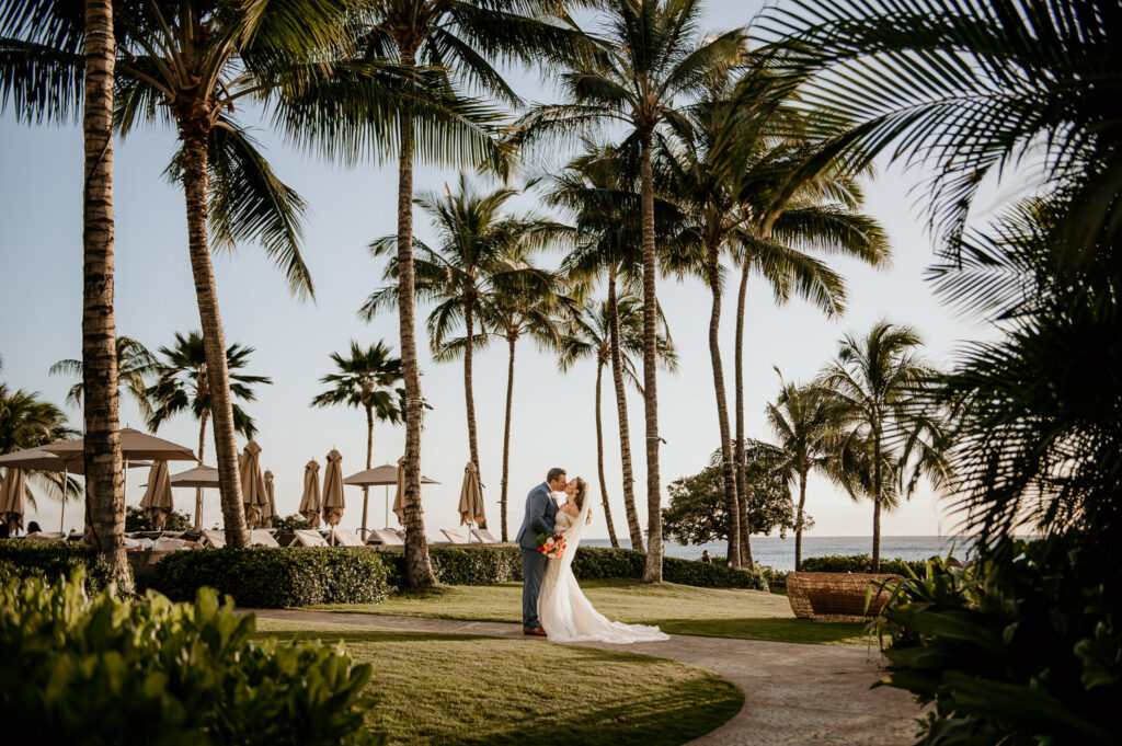 Bride and Groom portrait with palm trees in background.