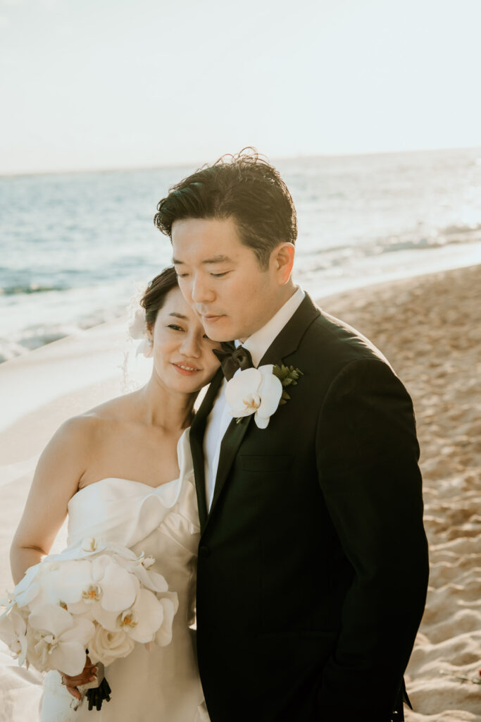 Romantic moment between Bride and Groom on the beach in front of Halekulani Hotel.