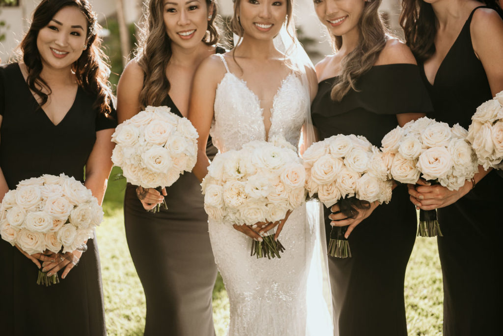 Bride and bridesmaids with white rose bouquets