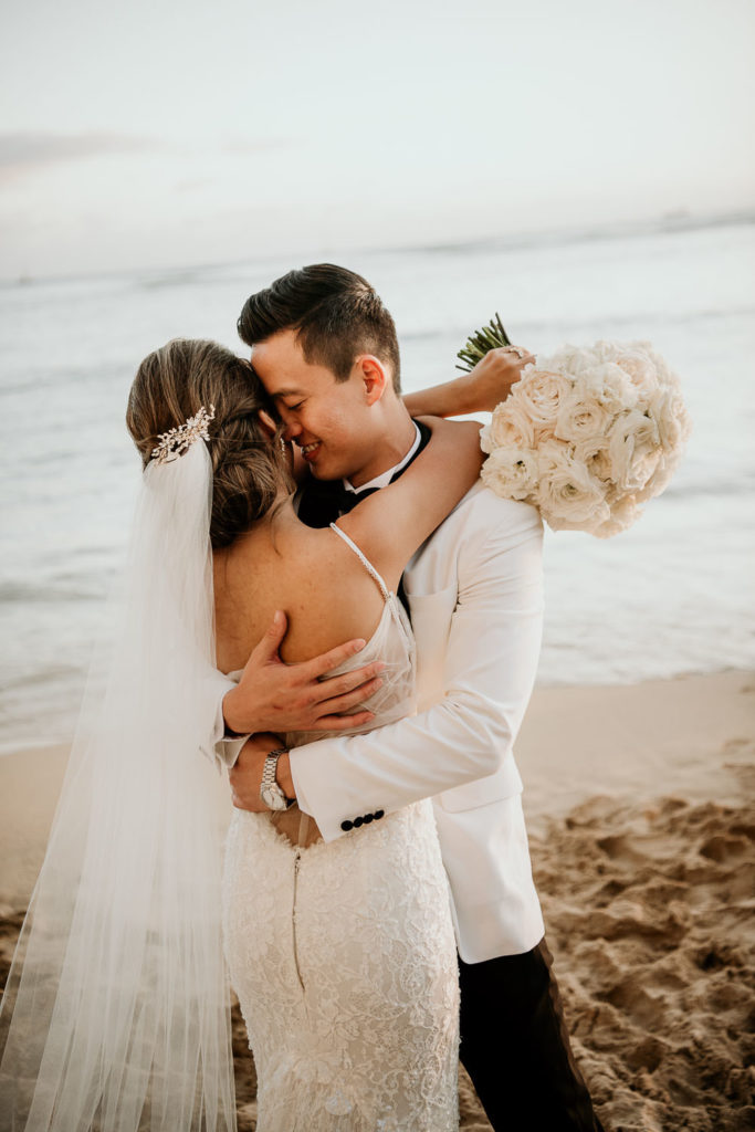 Groom kissing cheak of Bride on Waikiki Beach