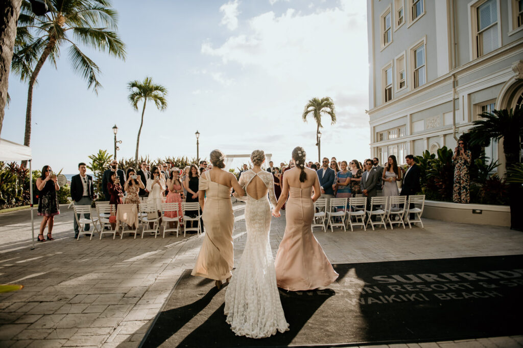 Back shot of the bride walking down the aisle at the Diamond Head lawn at the Moana Surfrider.