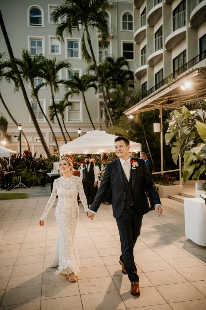 Bride and Groom walking to Reception at Moana Surfrider.