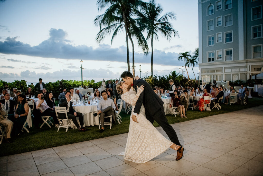 Groom dipping bride during the first dance at the Moana Surfrider.