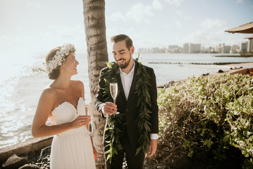 Bride and Groom Toast with Waikiki in the background